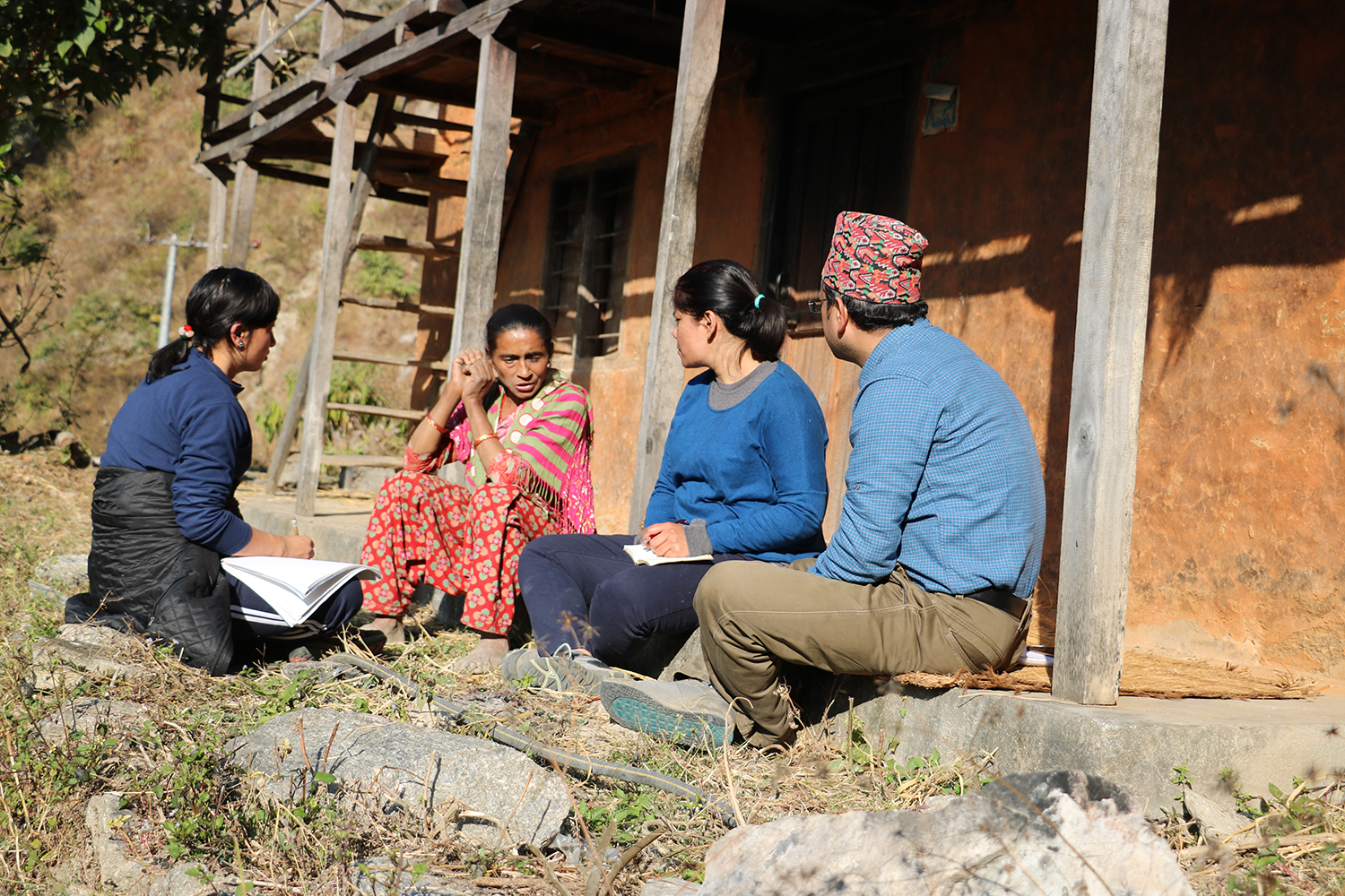 A group of people in Nepal sat down having a discussion